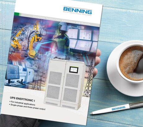 UPS ENERTRONIC I brochure on a desk with coffee and BENNING pen