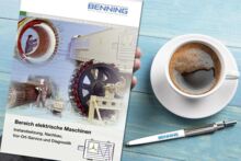 Electrical machines brochure on a table with coffee and ballpoint pen