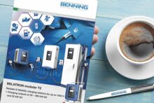 The new BELATRON modular T2 brochure is held in the hand next to a BENNING ballpoint pen and a coffee cup